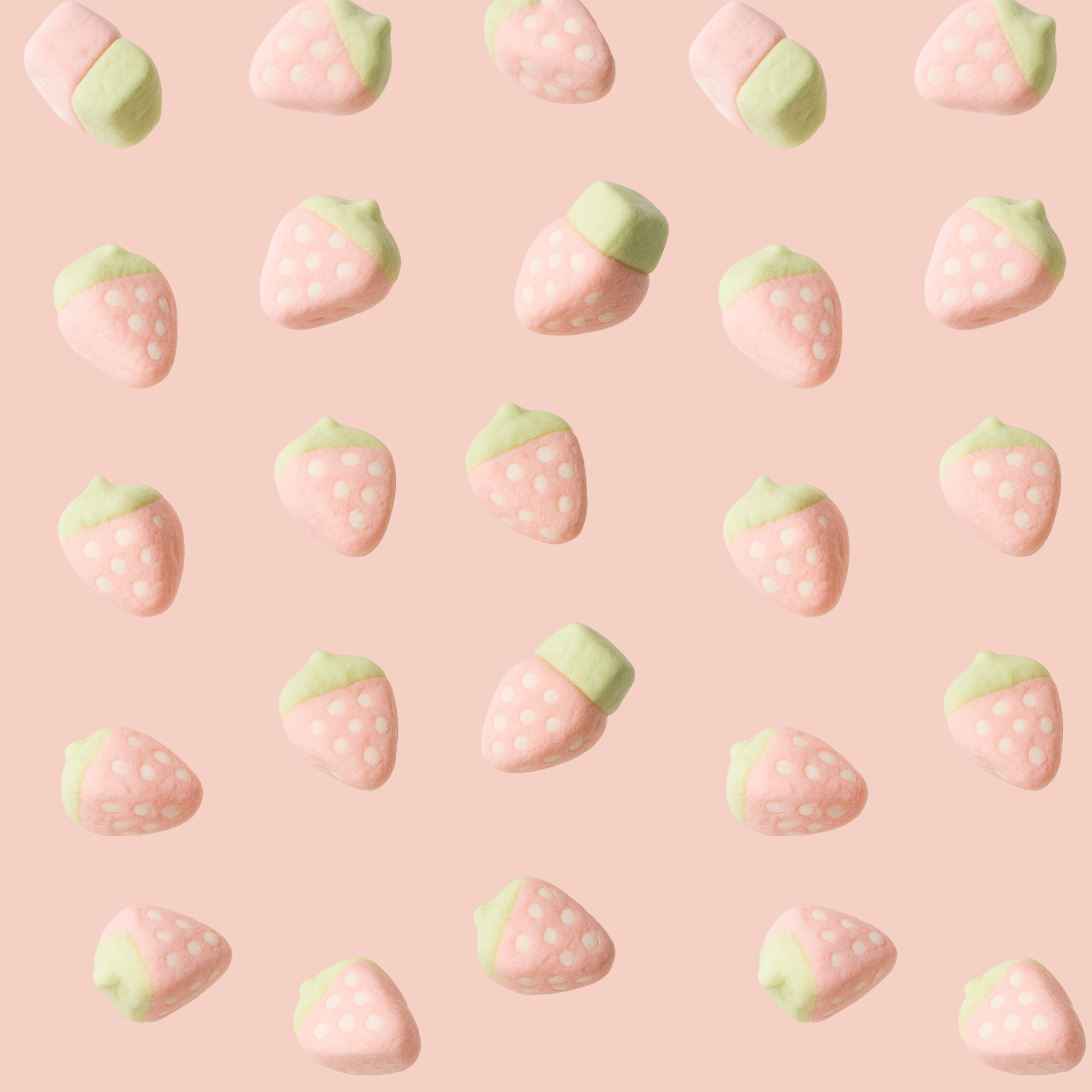 Halal strawberry mallows floating on a pink background.