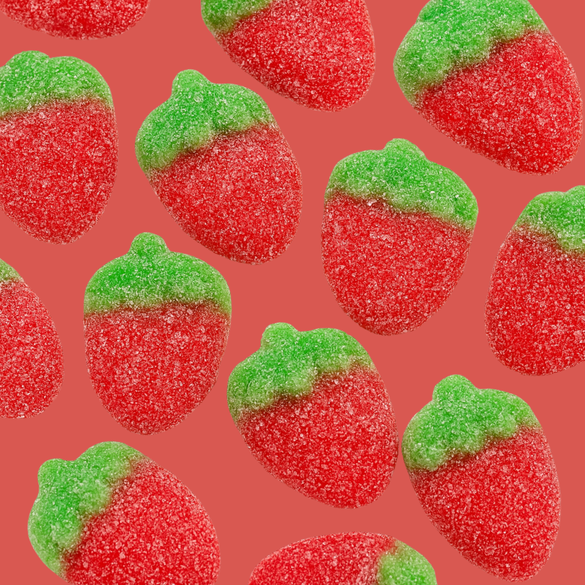 halal giant gummy strawberries against a red background.